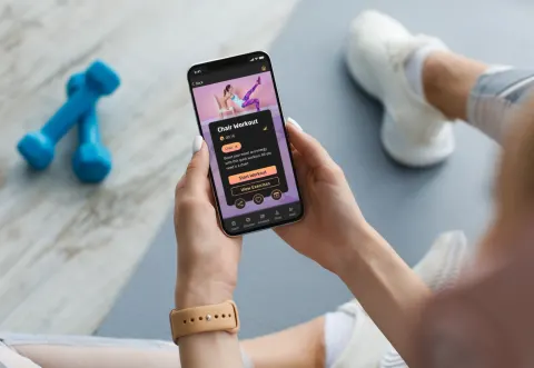woman holds smart phone displaying app